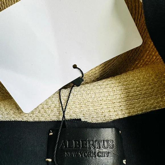 Albertus Swanepoel fedora. Natural raffia w/ shiny thread. Black satin band/bow. Women